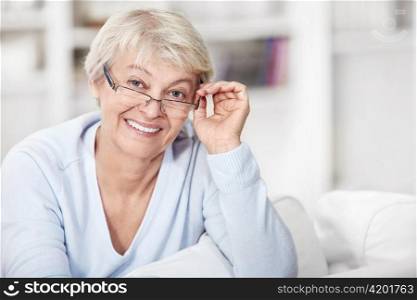 Mature woman with glasses at home