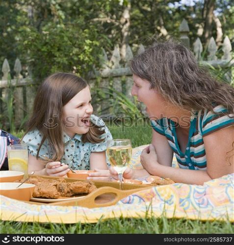Mature woman with her daughter having picnic