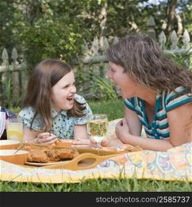 Mature woman with her daughter having picnic