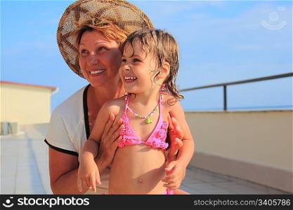 mature woman with little girl on veranda