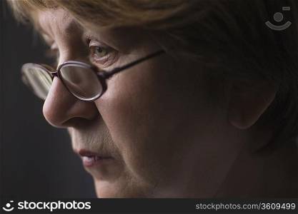Mature woman with reading glasses