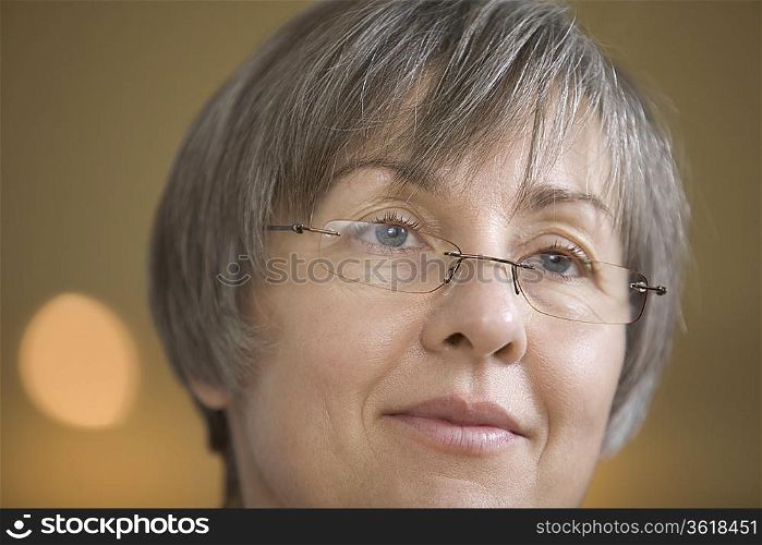Mature woman with short grey hair in spectacles