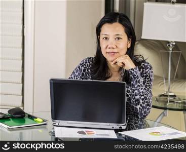 Mature women holding glasses while relaxing at home office