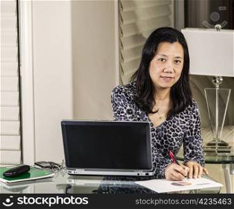 Mature women marking pie chart for comments while working at home