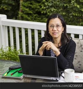 Mature women on outdoor deck working from home office