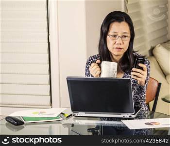 Mature women receiving message during work day at home office