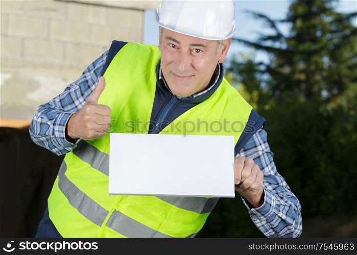mature worker builder shows thumb up and blank message