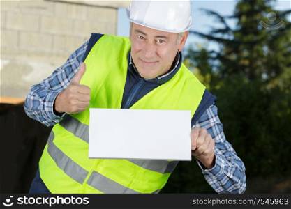mature worker builder shows thumb up and blank message