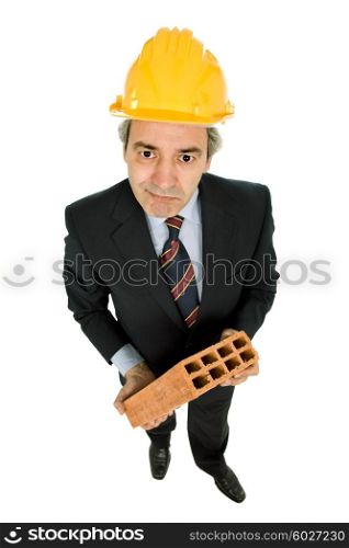 mature worker holding a brick, isolated on white