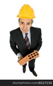 mature worker holding a brick, isolated on white