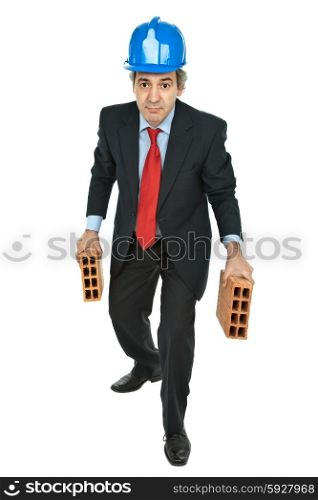 mature worker holding two bricks, isolated on white