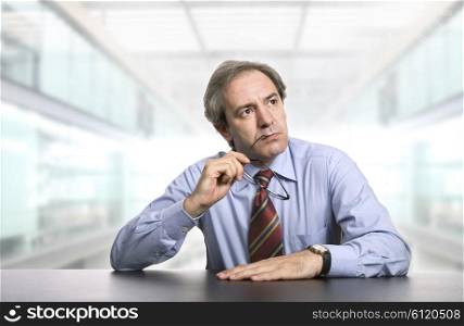 mature worried businessman on a desk, at the office