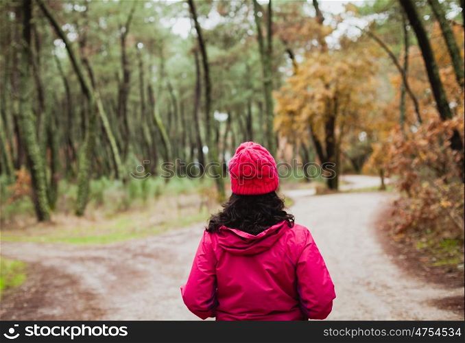 Matured woman hiking in the forest at winter