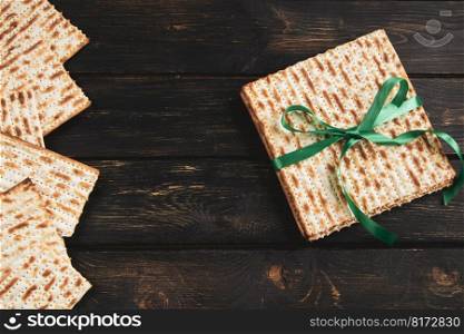 Matzah background. Happy Passover. Traditional Jewish regilious holiday Pesach. Matzo bread on dark wooden table.. Matzah background. Happy Passover. Traditional Jewish regilious holiday Pesach. Matzo bread on a dark wooden table.