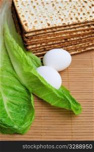 Matzot, eggs and lettuce - symbols of jewish passover.