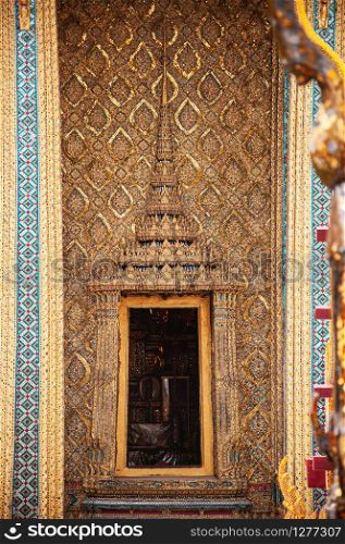 MAY 13, 2010 Bangkok, Thailand - Beautiful elegant Historic Golden carved wood Thai window and wall of Bangkok Grand Palace building - Wat Phra Kaew - Emerald Buddha temple