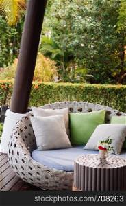 MAY 21, 2014 Krabi, THAILAND - Modern contemporary tropical Asian style sofa couch, pillows and garden view in background