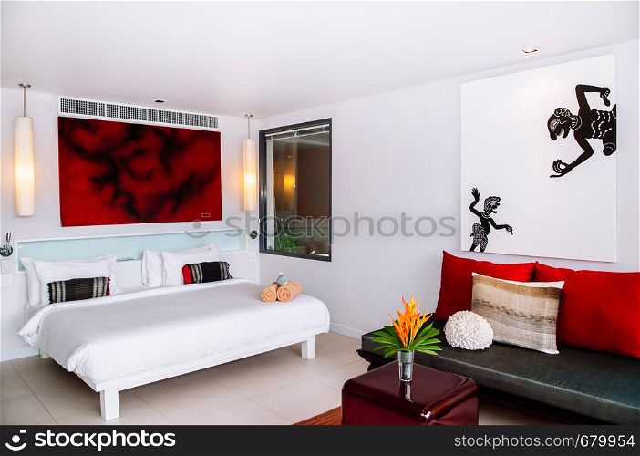 MAY 22,2014 Koh Lanta, Krabi, Thailand - White modern minimal bedroom interior with picture frame, furnitures, sofa couch, arcrylic table. Modern simple and clean interior design