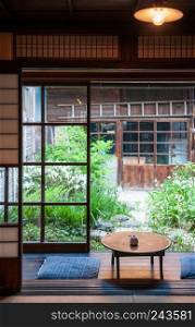 MAY 26, 2013 Gifu, JAPAN - Old Japanese houses interior with sliding door, indego fabric cusion and wood table. Famous warm atmosphere Melon bun shop cafe of Hida Furukawa town old historic town.