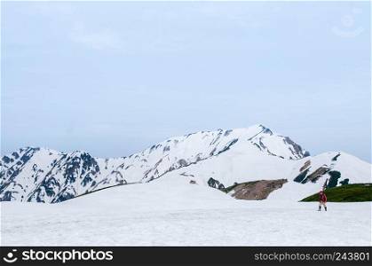 MAY 28, 2013 Toyama, Japan - Exotic nature view of Walking trail on snow mountain of Japan alps at Tateyama Kurobe Alpine Route with tourists enjoy cold wintrer scene