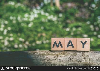 May month label in a green garden in the springtime