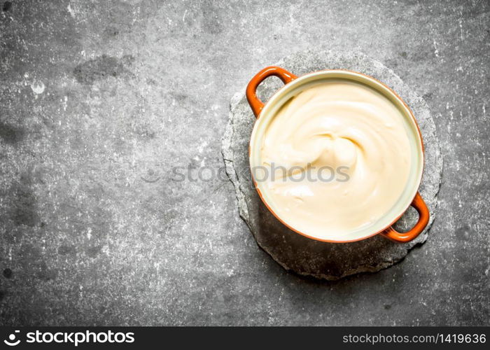 Mayonnaise in a bowl. On the stone table.. Mayonnaise in a bowl.