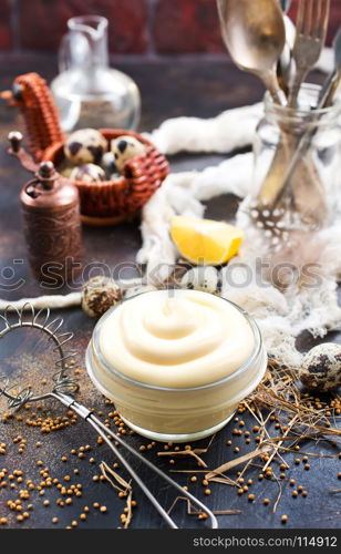 mayonnaise in glass bowl and on a table