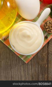 mayonnaise sauce in bowl on wooden background