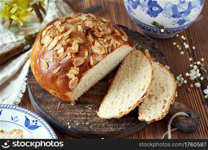Mazanec, traditional Czech sweet Easter pastry, similar to hot cross bun, on a table with a blue jug and plates