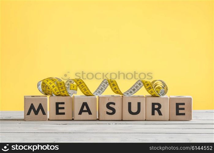 Measure tape on a wooden sign on a table