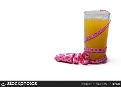 Measuring tape, glass of freshly squeezed orange juice. Images on white isolated background.. Measuring tape, glass of freshly squeezed orange juice.