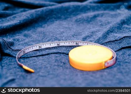 Measuring tape on the cotton cloth material with a blue color