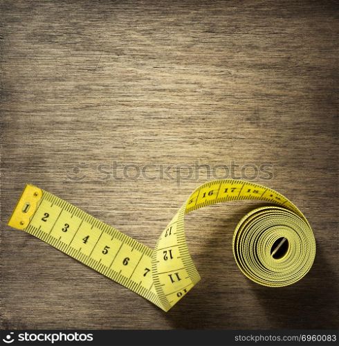 measuring tape on wooden background. measuring tape on wooden background surface