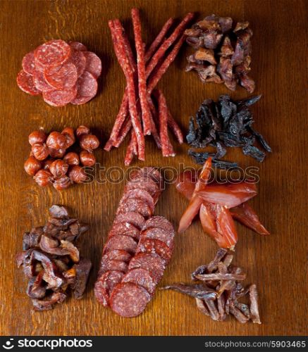 meat and sausages. different sausage and meat on a celebratory table with spices and vegetables