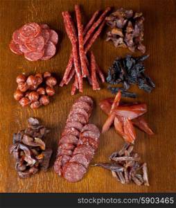 meat and sausages. different sausage and meat on a celebratory table with spices and vegetables