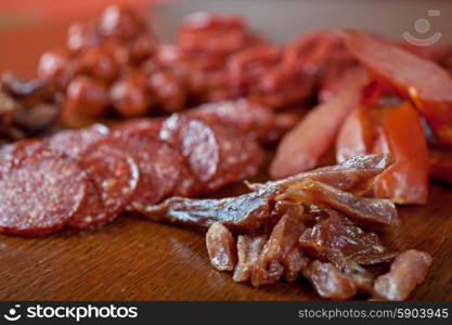 meat and sausages. different sausage and meat on a celebratory table with spices and vegetables