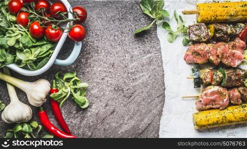 Meat and vegetables skewers cooking preparation for grill or roasting on grey concrete background, top view
