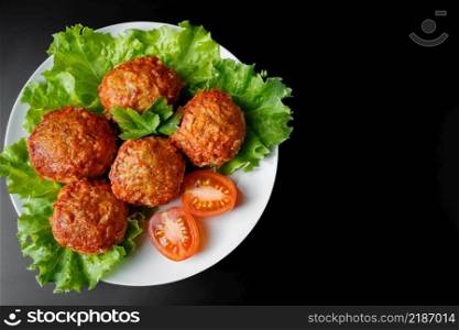 Meat balls in tomato sauce on a black background. Homemade protein meal for healthy eating.. Meat balls in tomato sauce on a black background. Homemade protein meal for healthy diet.
