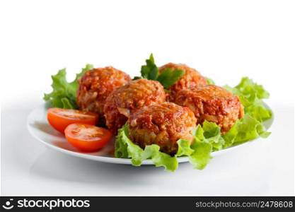 Meat balls in tomato sauce with vegetables isolated on a white background.. Meat balls in tomato sauce isolated on a white background.