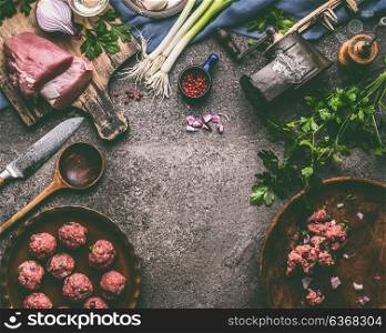 Meat balls meal cooking preparation with cooking spoon, kitchen tools and seasoning on rustic table background, top view, frame.