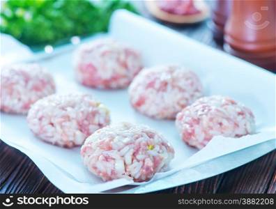 meat balls on metal tray and on a table