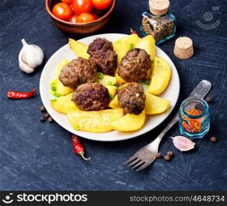 Meat balls with baked potatoes. Meat cutlets and fried potatoes for garnish.Copy space