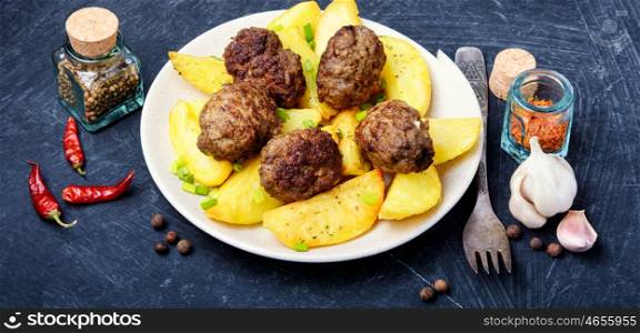 Meat balls with baked potatoes. Meat cutlets and fried potatoes for garnish.Ukrainian popular food