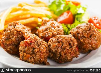 meat balls with fries and salad