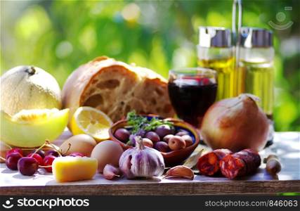 meat, brea and wine, spices and fruits on table