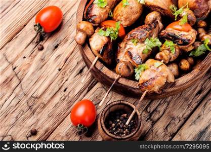 Meat chicken shish kebab with mushrooms and spices.Eastern food. Grilled shish kebab or shashlik