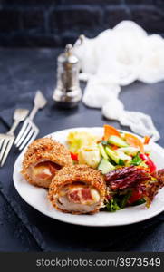 meat cutlet cordon bleu, cutlet with fresh salad on plate