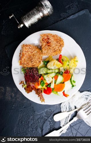 meat cutlet cordon bleu, cutlet with fresh salad on plate