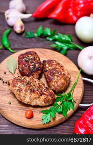 Meat cutlets on a wooden board, top view