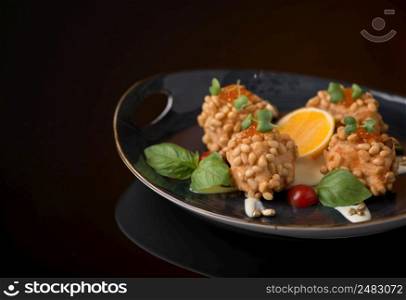 meat dish with nuts on a black background, isolated. dish on black background